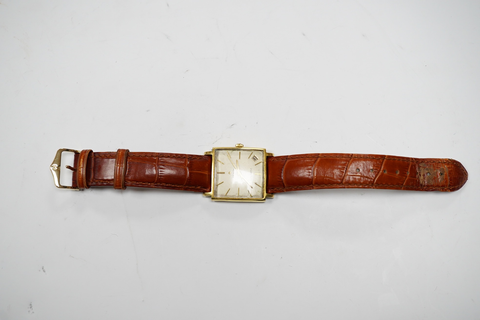 A gentleman's 18k Zenith Automatic square dial wrist watch, with baton numerals and date aperture, on an associated leather strap, case diameter 30mm. Condition - poor.